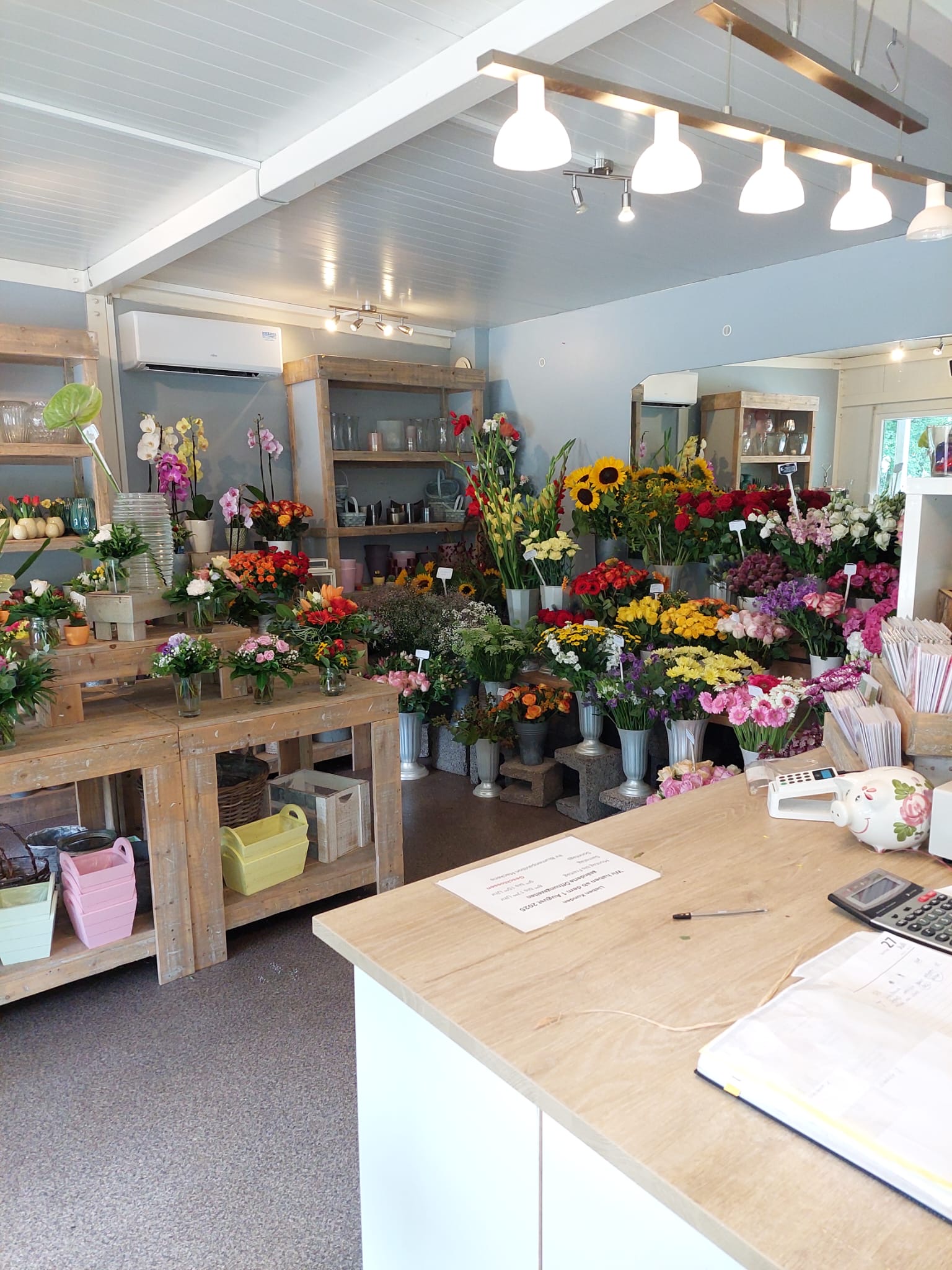 Blick in den Laden des Blumenpavillons mit bunten Blumensträußen